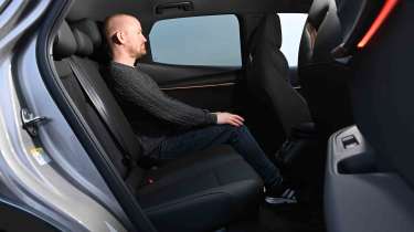 Cupra Tavascan – rear seats with Auto Express Chief reviewer, Alex Ingram