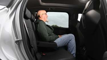 BMW iX3 2026 - rear seats, being sat in by Auto Express senior test editor Dean Gibson