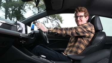 Auto Express content editor Ryan Birch sitting in the MG3
