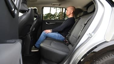 Auto Express chief reviewer Alex Ingram sitting in the Kia Niro EV&#039;s back seat