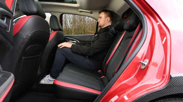 Ora 03 GT 2025 - rear seats being sat in by Auto Express staff writer Alastair Crooks 