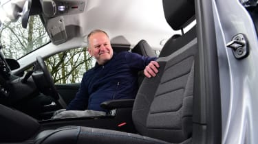 Auto Express executive editor Paul Adam feeling the Citroen C4 X&#039;s upholstery