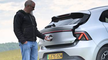 Auto Express senior test editor Dean Gibson opening the MG4 Urban's tailgate
