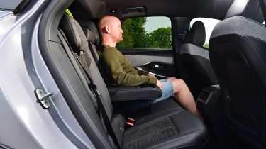 Auto Express chief reviewer Alex Ingram sitting in the Peugeot E-3008&#039;s back seat