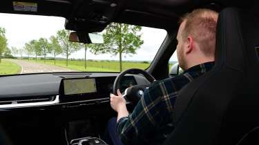 Auto Express news reporter Ellis Hyde driving the BMW iX1