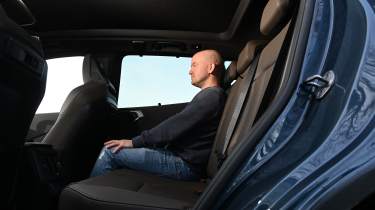 BMW X3 - rear seats being sat in by Auto Express chief reviewer Alex Ingram 