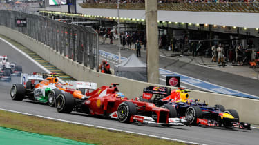 Fernando Alonso pushes through the first corner of the Brazilian Grand Prix