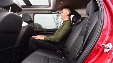 Auto Express deputy editor Richard Ingram sitting in the back seats of the Honda CR–V e:HEV