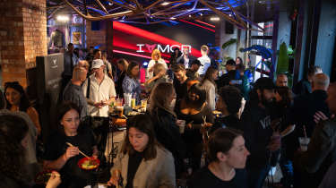 Crowd of people standing inside Cupra's Manchester garage