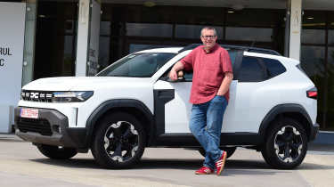 John McIlroy standing next to a brand-new Dacia Duster