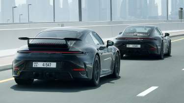 New Porsche 911&#039;s rear 3/4 driving down a road