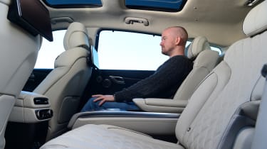 Auto Express chief reviewer Alex Ingram sitting in the back seat of the Genesis GV80