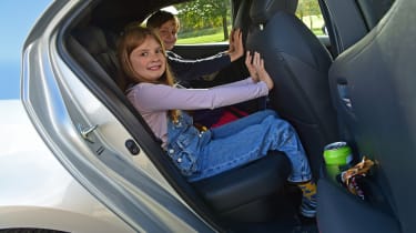 Auto Express features editor Chris Rosamond&#039;s children demonstrating the Toyota Corolla GR Sport&#039;s rear legroom