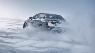 Camouflaged BMW i5 winter testing (official picture) - rear cornering