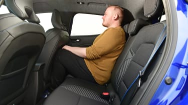 Auto Express news reporter Ellis Hyde testing the back seats of the facelifted Renault Clio