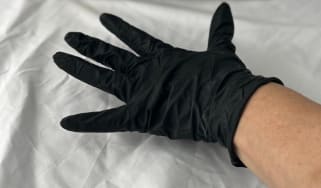 Hand wearing black glove