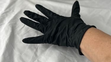 Hand wearing black glove