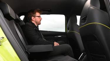 New Skoda Elroq vRS UK - rear seats being sat in by Auto Express onlie reviews editor Max Adams
