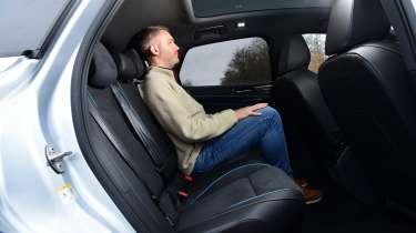 Auto Express deputy editor Richard Ingram sitting in the back seat of the Volkswagen ID.7