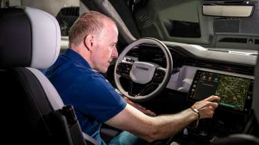 Phil McNamara sat in the Range Rover Sport Electric