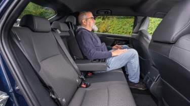 Auto Express senior test editor Dean Gibson sitting in the Toyota bZ4X's back seat