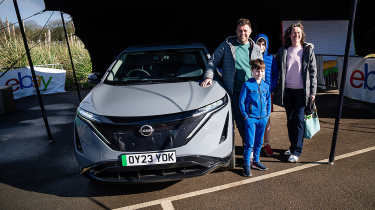 Auto Express head of digital content Steve Walker and family standing next to the Nissan Ariya