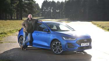 Cars to drive before they're gone feature - Darren Wilson standing next to a Ford Focus