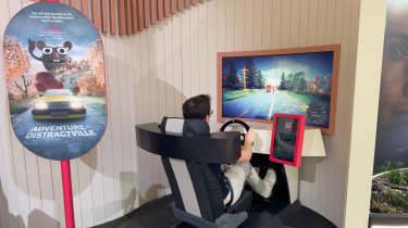 Auto Express consumer reporter Tom Jervis using a Volvo driving simulator