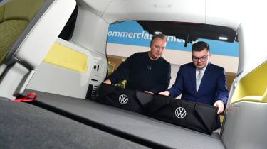 Auto Express editor-in-chief Steve Fowler inspecting the Volkswagen ID. Buzz&#039;s boot along with Volkswagen sales executive Tom Lodge 
