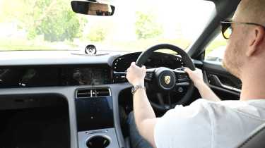 Porsche Taycan - interior shot with Chief reviewer, Alex Ingram driving
