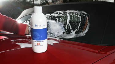 Auto Express Product Awards 2026 - products editor Tom Barnard washing his car with Bilt-Hamber Auto Wash car shampoo