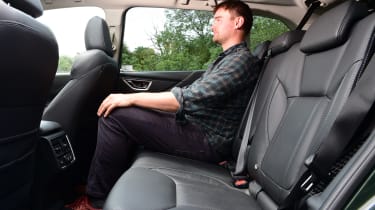 Auto Express staff writer Alastair Crooks sitting in the back seat of the 2023 Subaru Forester