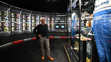 Damon Hill looking at a clothing display at the London F1 exhibition