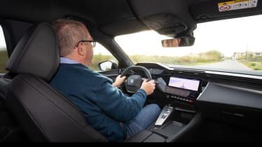Auto Express editor-at-large John McIlroy driving the Peugeot E-308 SW