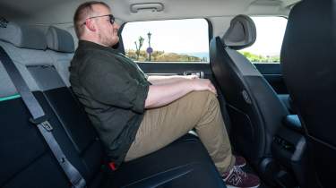 Ellis Hyde sitting in the Kia EV4