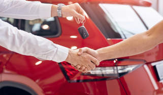 Car keys being handed over to a car buyer