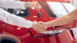 Car keys being handed over to a car buyer