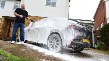 Auto Express contributor Tom Barnard covering the Mazda 3 in snow foam