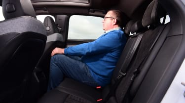Auto Express editor-at-large John McIlroy sitting in the back seat of the Peugeot E-3008