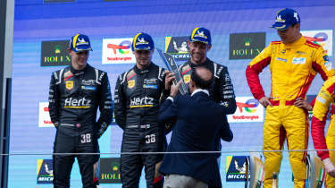 Le Mans drivers standing on podium