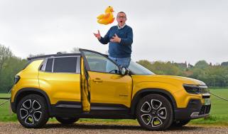 Auto Express editor-at-large John McIlroy standing on the Jeep Avenger&#039;s door sill while holding an inflatable duck 