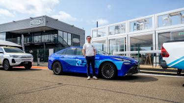 Auto Express consumer reporter Tom Jervis stood in front of a Toyota Mirai