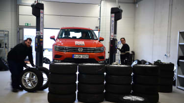 Volkswagen Tiguan on workshop ramp being fitted with new tyres