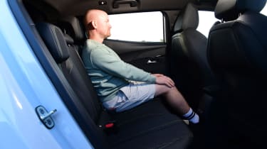 Auto Express chief reviewer Alex Ingram sitting in the Peugeot E-2008&#039;s back seat