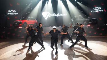 Dancers posing in front of two Chery SUVs
