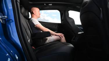 Auto Express contributor Alex Ingram sitting in the Aston Martin DBX S's rear seat