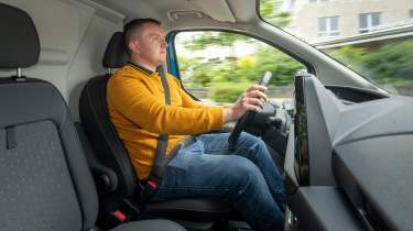 Auto Express senior content editor Shane Wilkinson driving the Ford E-Transit Custom