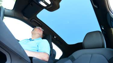 Auto Express editor-at-large John McIlroy looking at the Polestar 2 Single Motor&#039;s panoramic roof