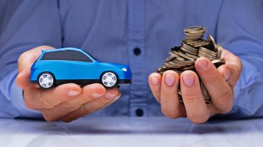 Hands holding a toy car and coins