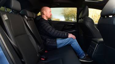 Former Auto Express contributor Alex Ingram sitting in the Subaru Solterra's rear seats